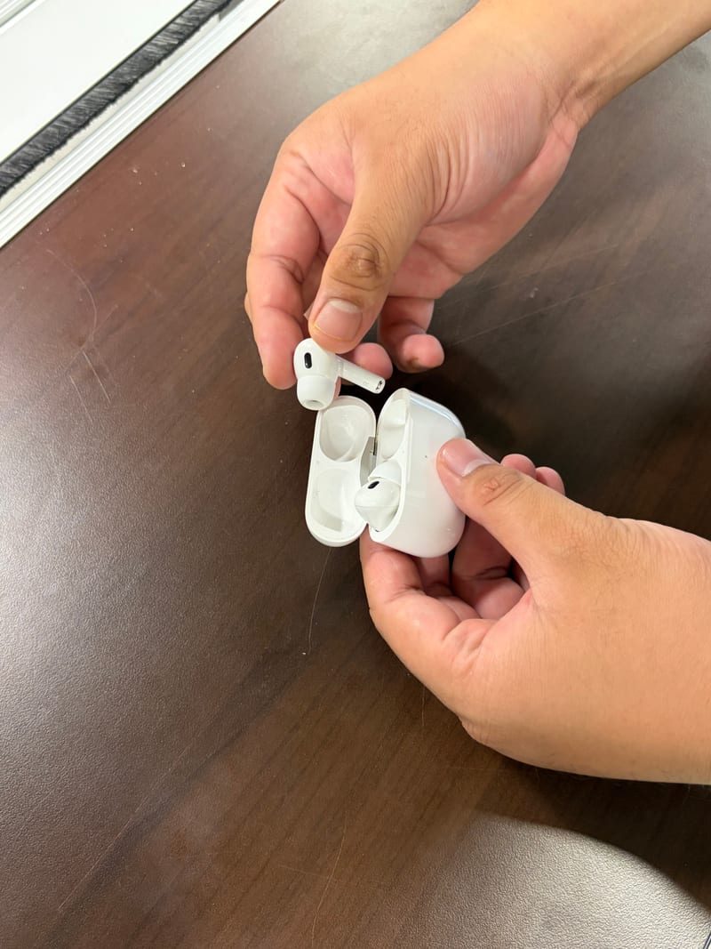 Inspecting AirPods Pro 2 with the charging case open at the Berry Nice counter