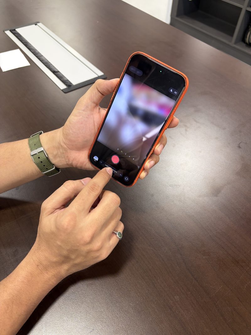 Berry Nice staff testing iPhone camera during buyback inspection