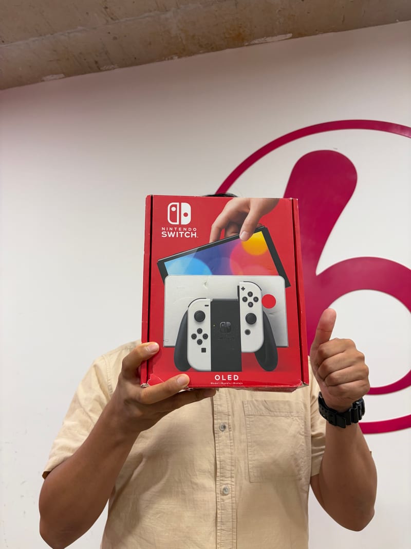 Berry Nice staff holding a Nintendo Switch OLED box ready for buyback inspection