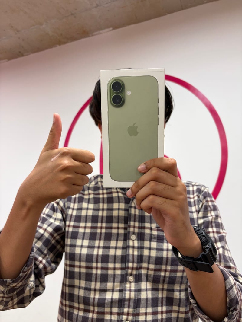 Berry Nice staff with an iPhone box in front of the brand wall