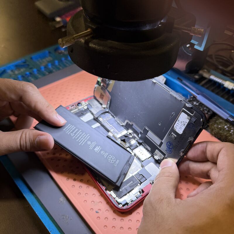 Berry Nice technician replacing an iPhone battery at the repair bench in Sentul, KL